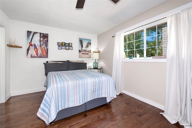 676 Ravensworth Dr, Conroe, TX 77302 - bedroom with wood finished floors, baseboards, and a ceiling fan
