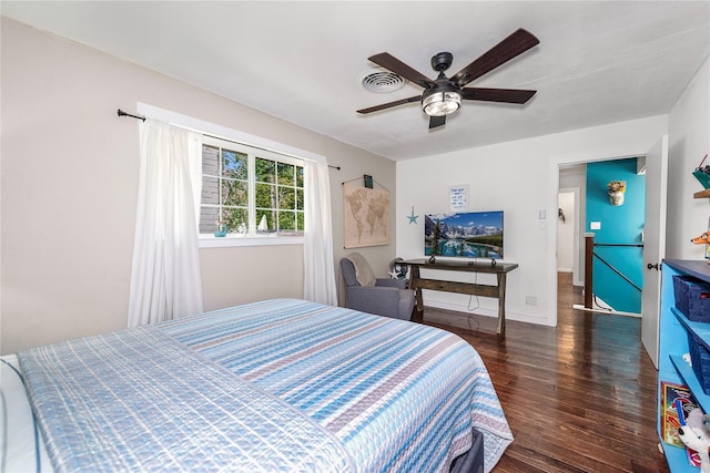 676 Ravensworth Dr, Conroe, TX 77302 - bedroom featuring dark wood-style flooring, a ceiling fan, and baseboards