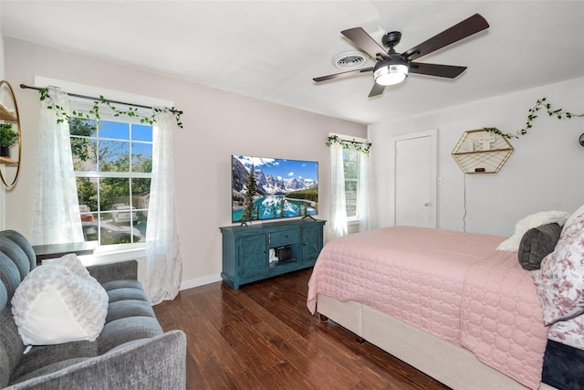 676 Ravensworth Dr, Conroe, TX 77302 - bedroom featuring wood finished floors, multiple windows, ceiling fan, and baseboards