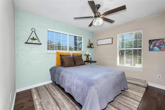 676 Ravensworth Dr, Conroe, TX 77302 - bedroom featuring wood finished floors, baseboards, and a ceiling fan