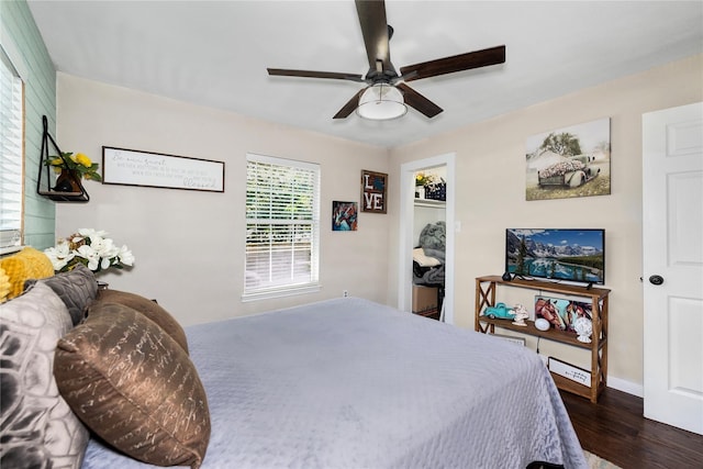 676 Ravensworth Dr, Conroe, TX 77302 - bedroom with wood finished floors, baseboards, and ceiling fan