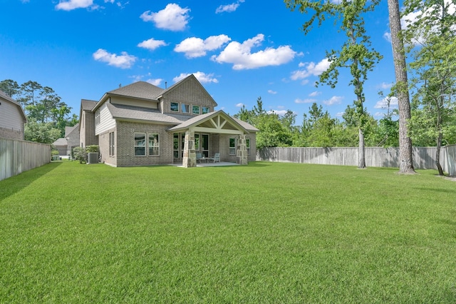 503 Woodsy Pine Ct, Conroe, TX 77304 - back of house with central air condition unit, brick siding, and a patio