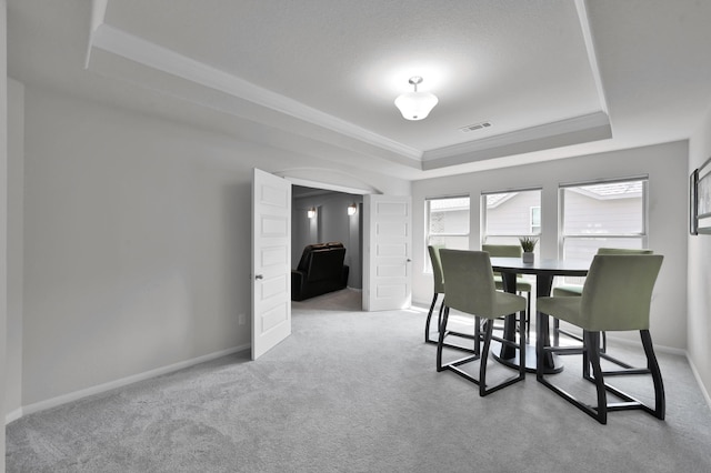 503 Woodsy Pine Ct, Conroe, TX 77304 - dining area featuring a raised ceiling, carpet, baseboards, and crown molding