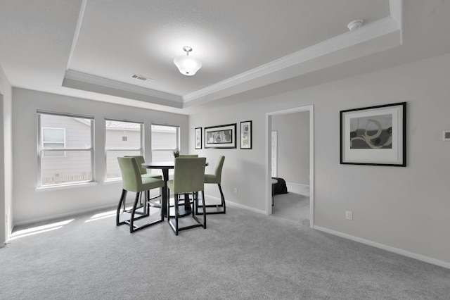 503 Woodsy Pine Ct, Conroe, TX 77304 - dining area featuring a tray ceiling, ornamental molding, carpet floors, and baseboards