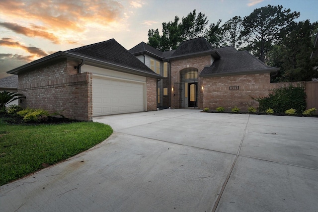 1438 Trace Dr, Houston, TX 77077 - view of front facade with brick siding, an attached garage, and concrete driveway