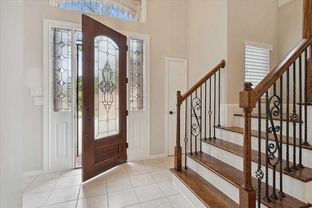1438 Trace Dr, Houston, TX 77077 - entrance foyer with a towering ceiling, plenty of natural light, baseboards, tile patterned floors, and stairway