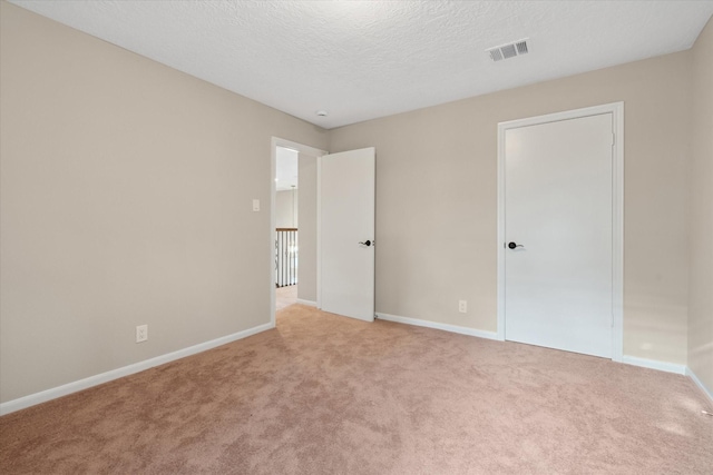 1438 Trace Dr, Houston, TX 77077 - unfurnished bedroom with carpet flooring, baseboards, and a textured ceiling
