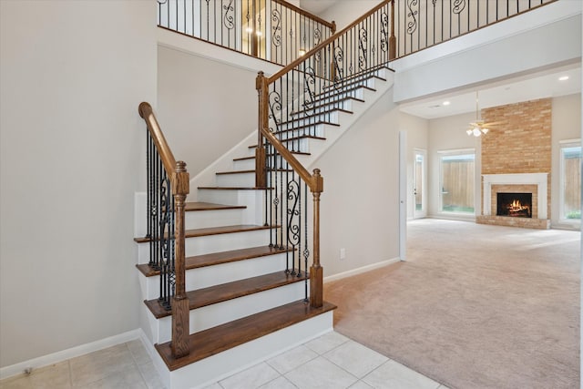 1438 Trace Dr, Houston, TX 77077 - stairs with a high ceiling, carpet, a ceiling fan, baseboards, and a fireplace