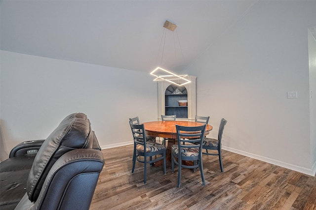2023 Wilcrest Dr, Houston, TX 77042 - dining area with wood finished floors, baseboards, a chandelier, and vaulted ceiling