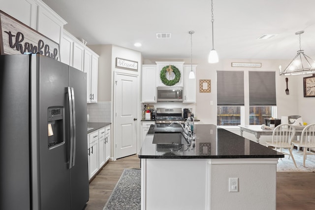 31110 Birch Mills Dr, Hockley, TX 77447 - kitchen featuring appliances with stainless steel finishes, dark wood finished floors, white cabinets, and recessed lighting