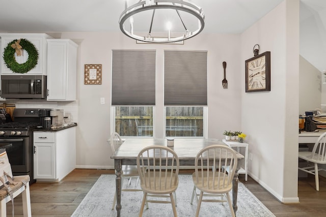 31110 Birch Mills Dr, Hockley, TX 77447 - dining space featuring light wood-style flooring, baseboards, and a chandelier