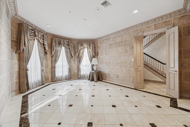 903 Old Lake Rd, Houston, TX 77057 - unfurnished room featuring tile walls, inlaid floor details, recessed lighting, and stairway
