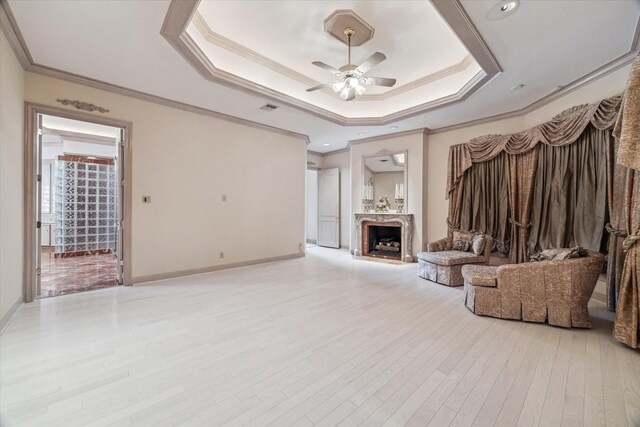 903 Old Lake Rd, Houston, TX 77057 - unfurnished living room featuring ceiling fan, a fireplace, ornamental molding, wood finished floors, and baseboards
