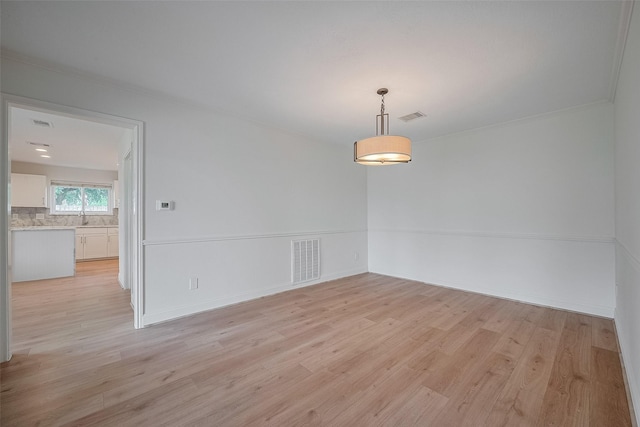 2543 Forge Stone Dr, Friendswood, TX 77546 - spare room featuring light wood-style flooring and crown molding