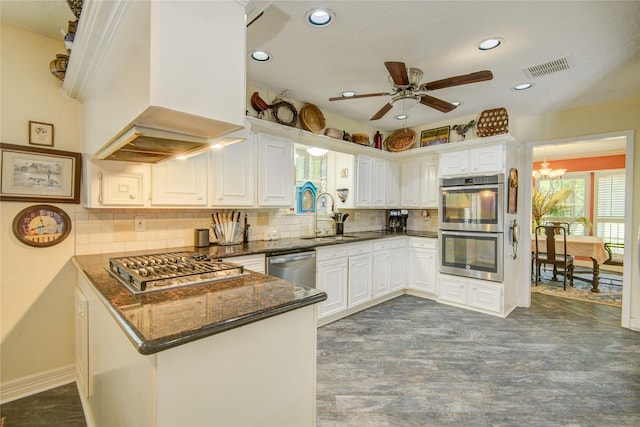 16814 Creeksouth Rd, Houston, TX 77068 - kitchen featuring a sink, appliances with stainless steel finishes, a peninsula, a ceiling fan, and dark stone countertops