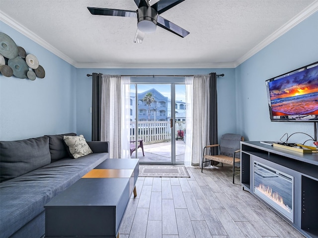 6300 Seawall Blvd Unit 3123, Galveston, TX 77551 - living area featuring a textured ceiling, light wood-type flooring, a ceiling fan, and ornamental molding