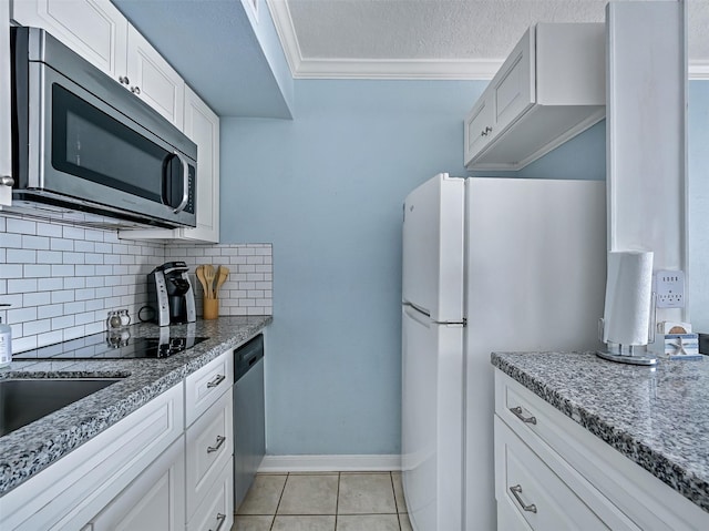 6300 Seawall Blvd Unit 3123, Galveston, TX 77551 - kitchen featuring stainless steel appliances, ornamental molding, decorative backsplash, a textured ceiling, and stone counters