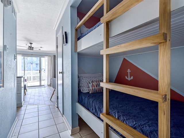 6300 Seawall Blvd Unit 3123, Galveston, TX 77551 - bedroom with tile patterned flooring, access to outside, baseboards, and a textured ceiling