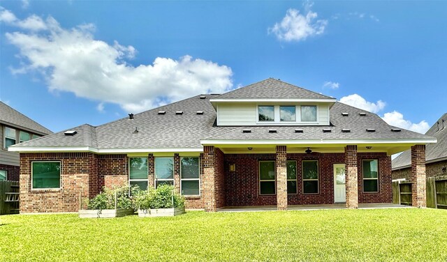 9314 Wheatfield Ln, Rosenberg, TX 77469 - back of house featuring a patio area, brick siding, and a shingled roof