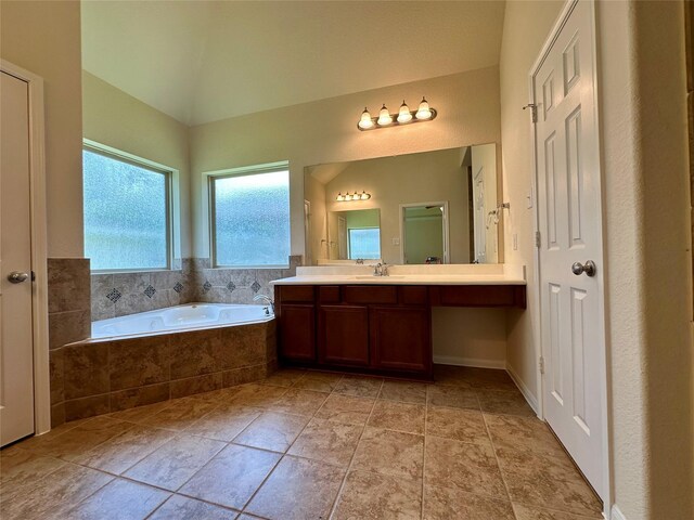 9314 Wheatfield Ln, Rosenberg, TX 77469 - bathroom with a bath, vanity, and lofted ceiling