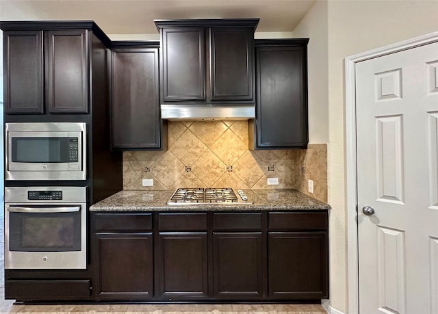 9314 Wheatfield Ln, Rosenberg, TX 77469 - kitchen featuring stainless steel appliances, tasteful backsplash, stone counters, and under cabinet range hood