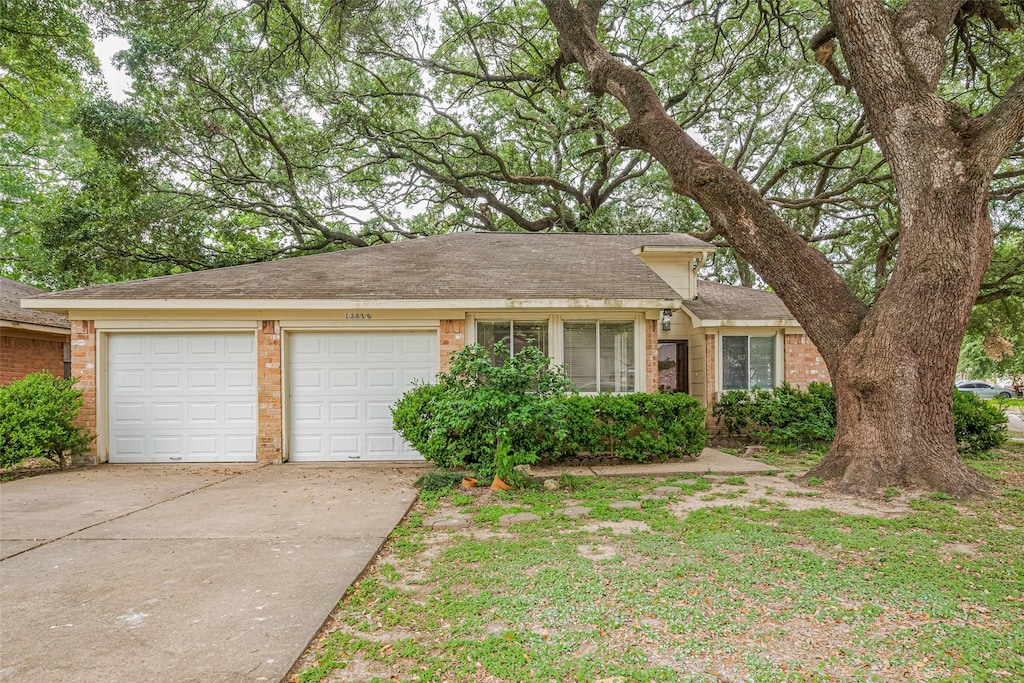13818 Kensington Pl, South Houston, TX 77034 - view of front of property with brick siding, concrete driveway, a garage, and roof with shingles