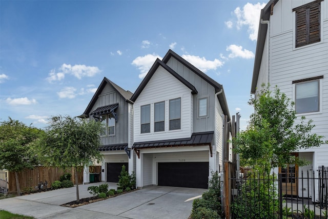 1608 Chestnut St, Houston, TX 77009 - view of front of property with board and batten siding, a garage, driveway, and a standing seam roof