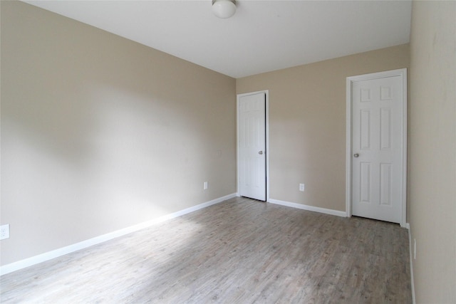 16726 Warbler Dr, Conroe, TX 77385 - unfurnished bedroom featuring wood finished floors, baseboards, and a closet