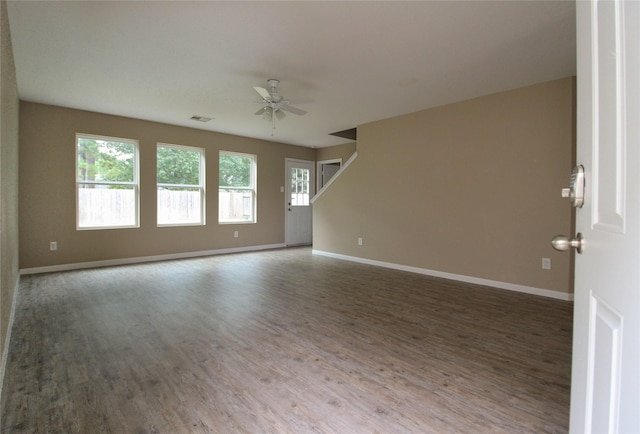 16726 Warbler Dr, Conroe, TX 77385 - empty room featuring wood finished floors, a ceiling fan, and baseboards
