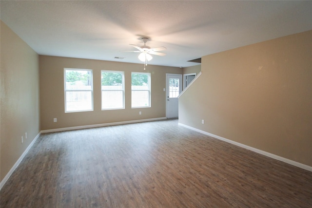 16726 Warbler Dr, Conroe, TX 77385 - spare room featuring wood finished floors, ceiling fan, and baseboards