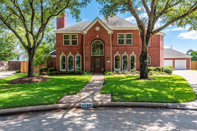 5706 Amber Queen Ct, Houston, TX 77041 - view of front of property featuring brick siding, a chimney, a garage, concrete driveway, and roof with shingles