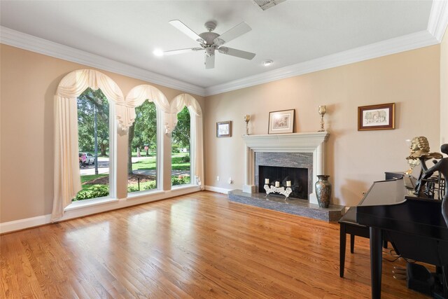 5706 Amber Queen Ct, Houston, TX 77041 - living area featuring a high end fireplace, ornamental molding, wood finished floors, ceiling fan, and baseboards