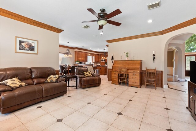 5706 Amber Queen Ct, Houston, TX 77041 - living room with crown molding, ceiling fan, light tile patterned floors, arched walkways, and recessed lighting