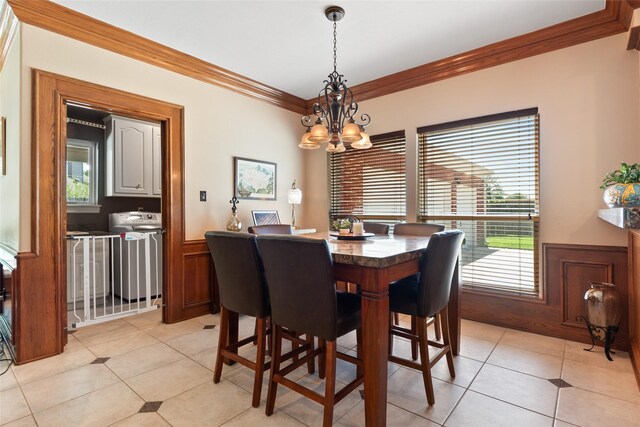 5706 Amber Queen Ct, Houston, TX 77041 - dining area featuring ornamental molding, a wainscoted wall, a chandelier, and light tile patterned floors
