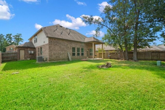 910 S Chamfer Way, Crosby, TX 77532 - rear view of house featuring brick siding and central air condition unit
