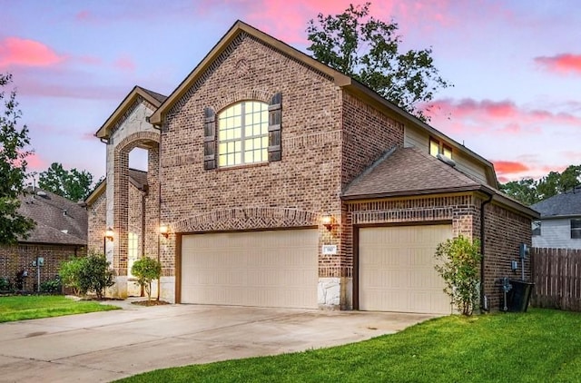 910 S Chamfer Way, Crosby, TX 77532 - french country inspired facade with brick siding, concrete driveway, roof with shingles, and an attached garage