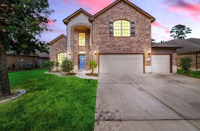 910 S Chamfer Way, Crosby, TX 77532 - view of front facade with brick siding, a front lawn, driveway, a garage, and central AC unit