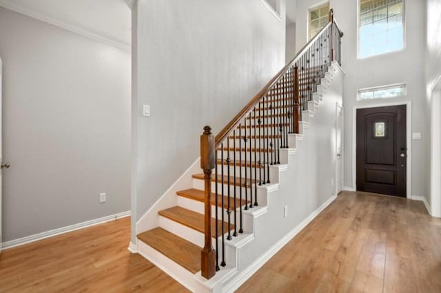 910 S Chamfer Way, Crosby, TX 77532 - entrance foyer with wood finished floors, stairway, baseboards, and a towering ceiling