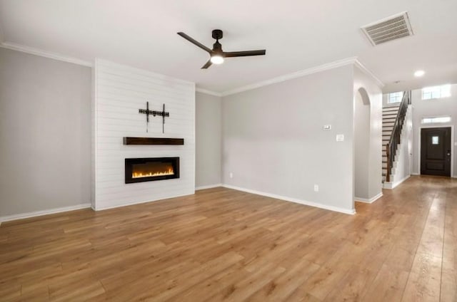 910 S Chamfer Way, Crosby, TX 77532 - unfurnished living room featuring ceiling fan, crown molding, light wood-type flooring, a fireplace, and baseboards
