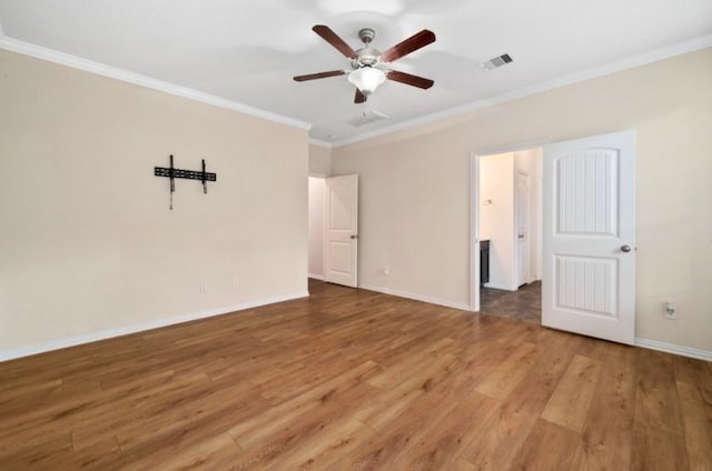 910 S Chamfer Way, Crosby, TX 77532 - spare room featuring wood finished floors, crown molding, a ceiling fan, and baseboards