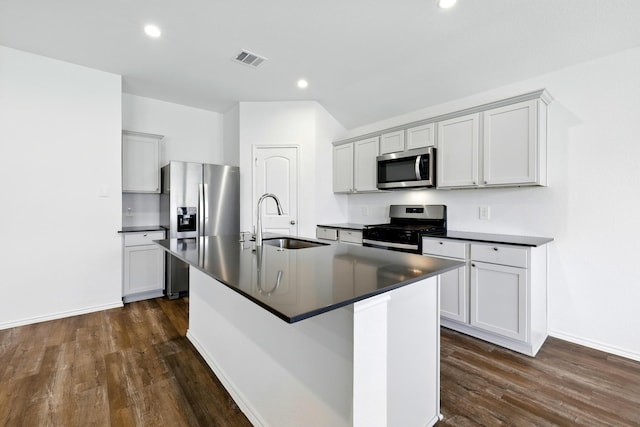 40518 Crisp Beech St, Magnolia, TX 77354 - kitchen featuring stainless steel appliances, a sink, dark countertops, dark wood finished floors, and recessed lighting