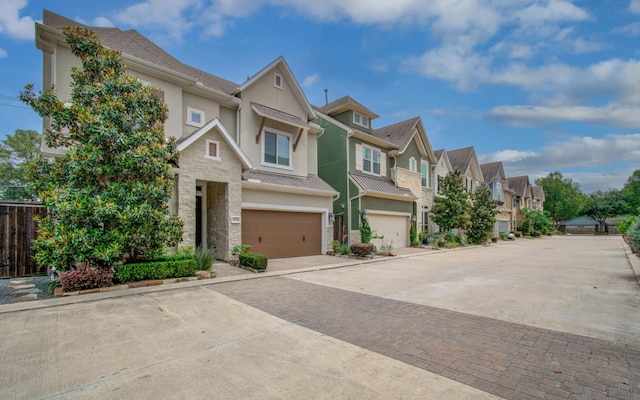 5726 Brancott Way, Houston, TX 77096 - townhome / multi-family property with stucco siding, a residential view, stone siding, a garage, and decorative driveway