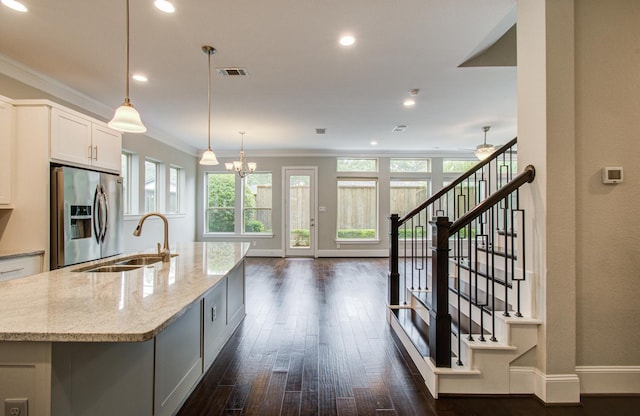 5726 Brancott Way, Houston, TX 77096 - kitchen with stainless steel refrigerator with ice dispenser, a sink, a kitchen island with sink, light stone countertops, and dark wood-style floors