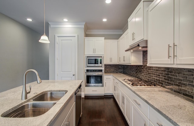 5726 Brancott Way, Houston, TX 77096 - kitchen featuring appliances with stainless steel finishes, a sink, under cabinet range hood, ornamental molding, and light stone counters