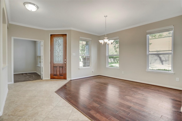 5402 Bending Branch Dr, Missouri City, TX 77459 - foyer entrance featuring a chandelier, ornamental molding, baseboards, and light wood-style floors