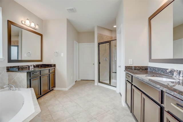5402 Bending Branch Dr, Missouri City, TX 77459 - full bathroom featuring a shower stall, a bath, two vanities, and tile patterned flooring