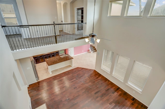 5402 Bending Branch Dr, Missouri City, TX 77459 - stairs with wood finished floors, a ceiling fan, and arched walkways