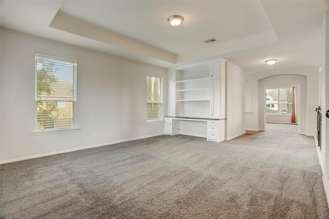 5402 Bending Branch Dr, Missouri City, TX 77459 - unfurnished living room featuring a raised ceiling and light colored carpet