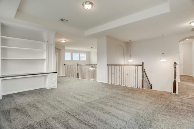 5402 Bending Branch Dr, Missouri City, TX 77459 - empty room with carpet floors, a raised ceiling, and arched walkways