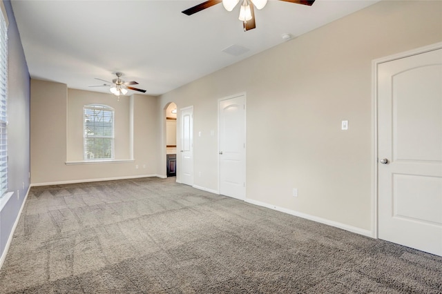 5402 Bending Branch Dr, Missouri City, TX 77459 - carpeted spare room with a ceiling fan, baseboards, arched walkways, and a smoke detector